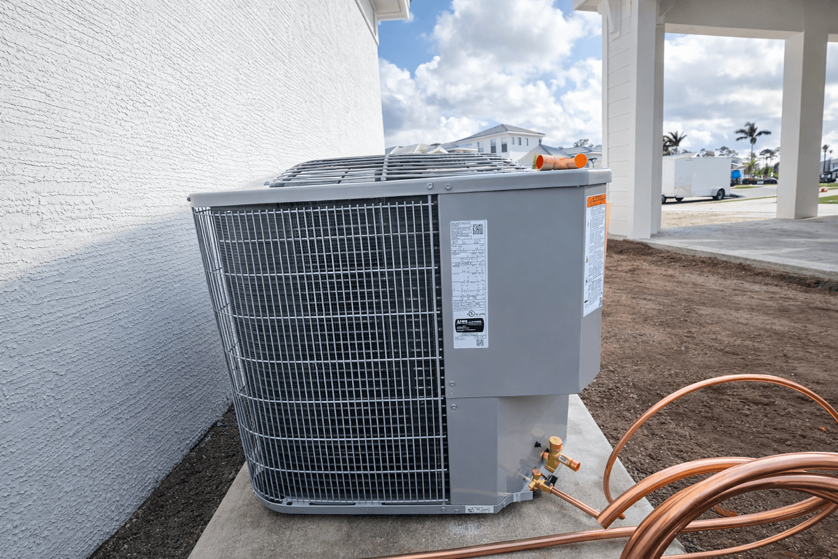 Outdoor AC condenser unit next to a Florida home ready for service